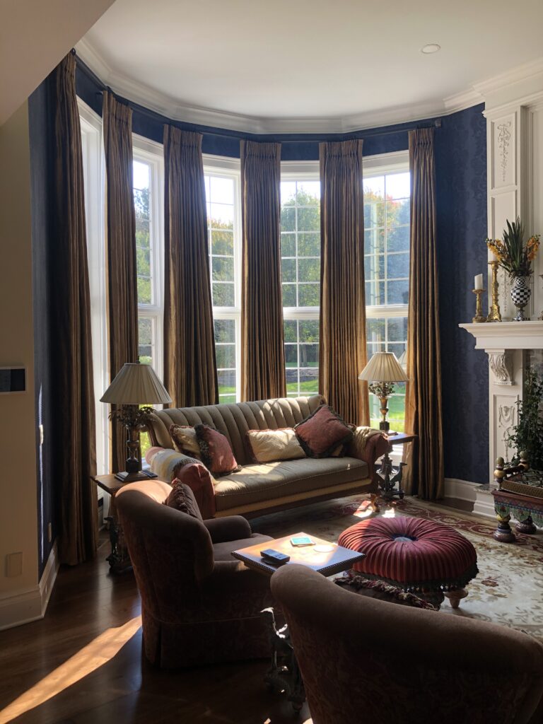 Five-sided bay window with independently motorized custom drapery panels