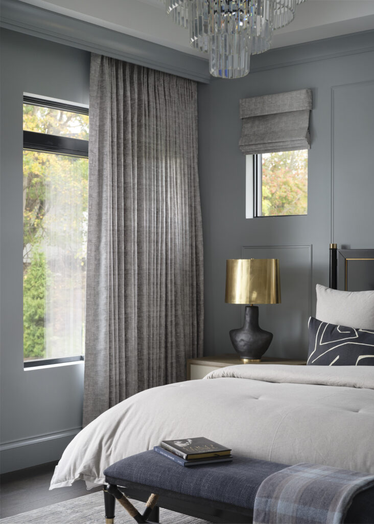Motorized panels tucked under decorative trim, with a matching roman shade.