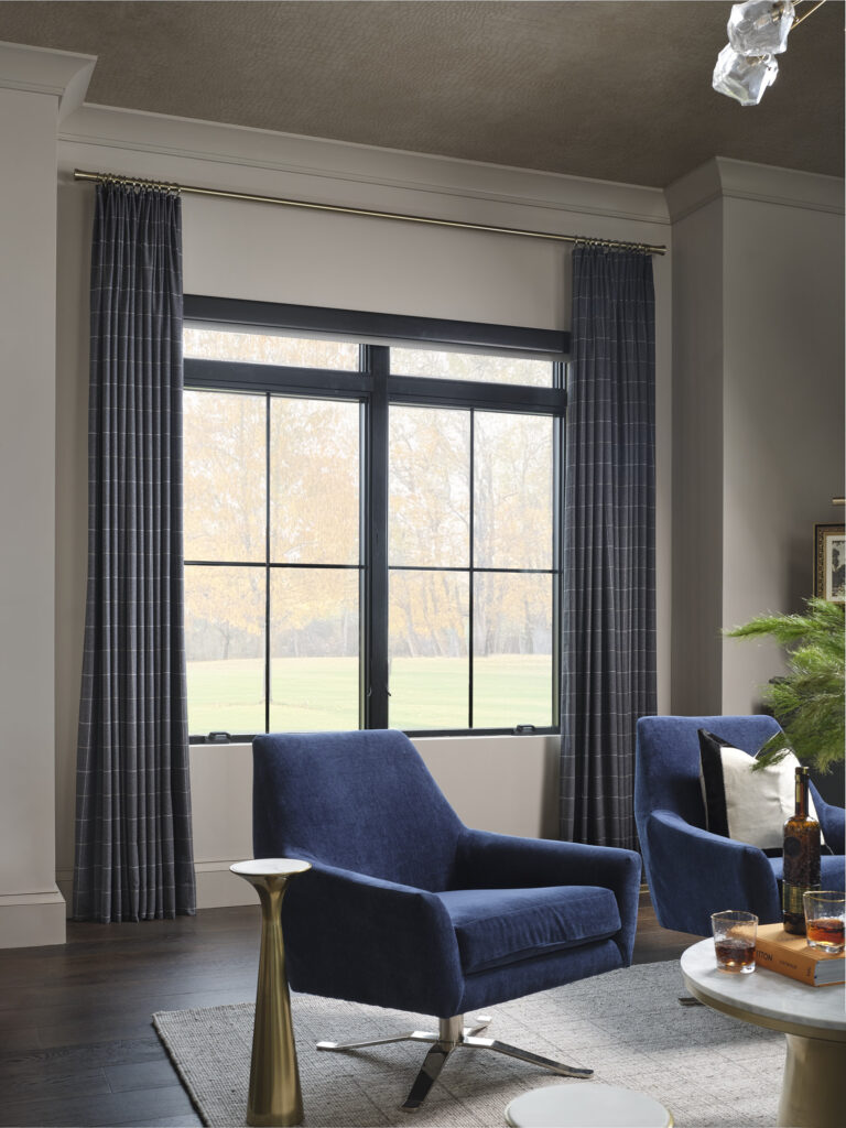 Stationary panels paired with a motorized roman shade that disappears when raised.