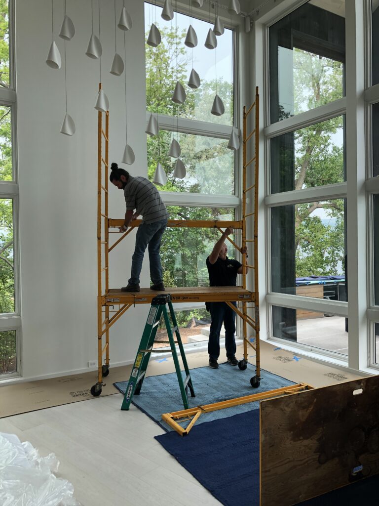 Installers preparing scaffolding for a tall job.