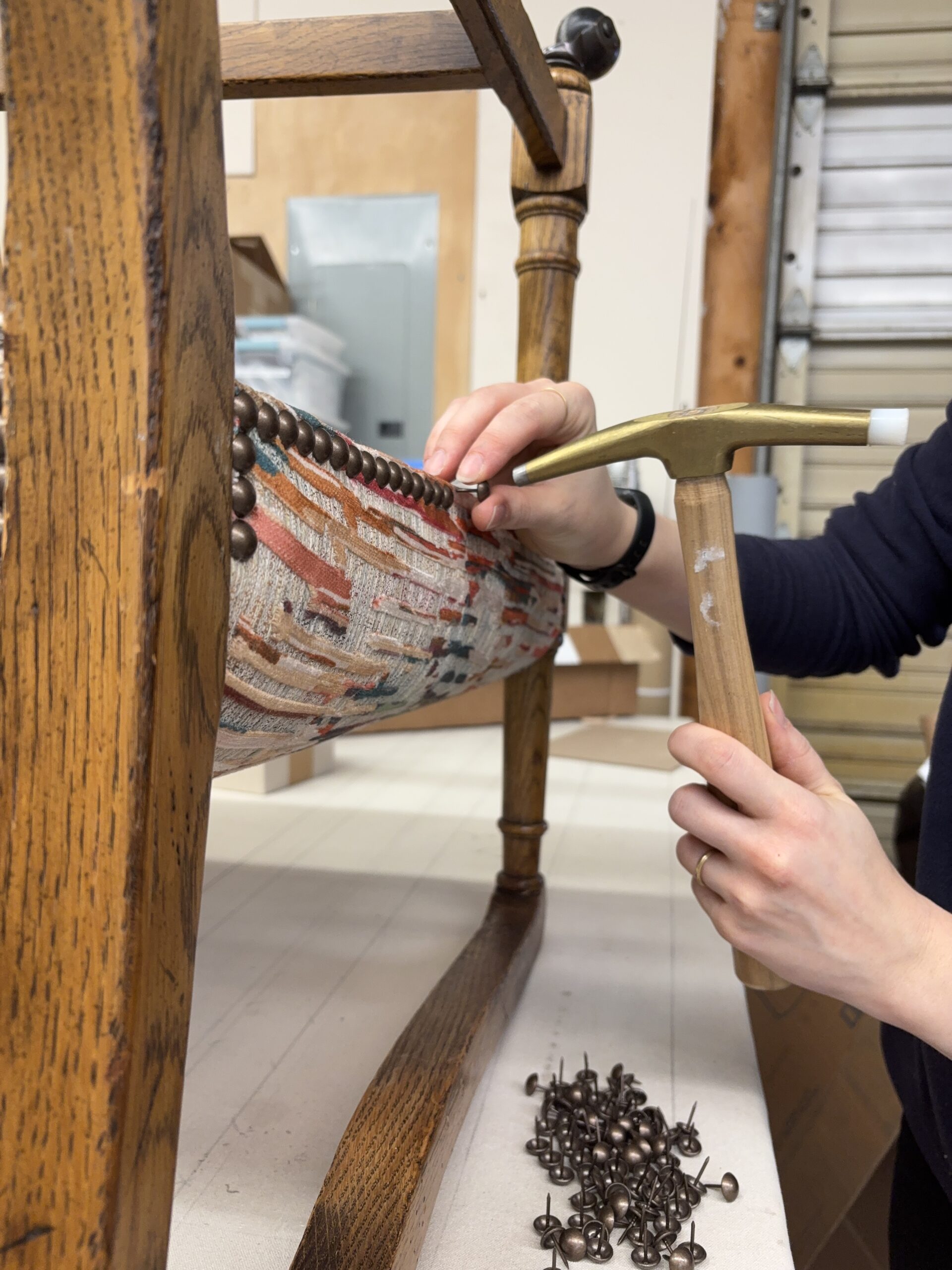 Hand placing nail heads