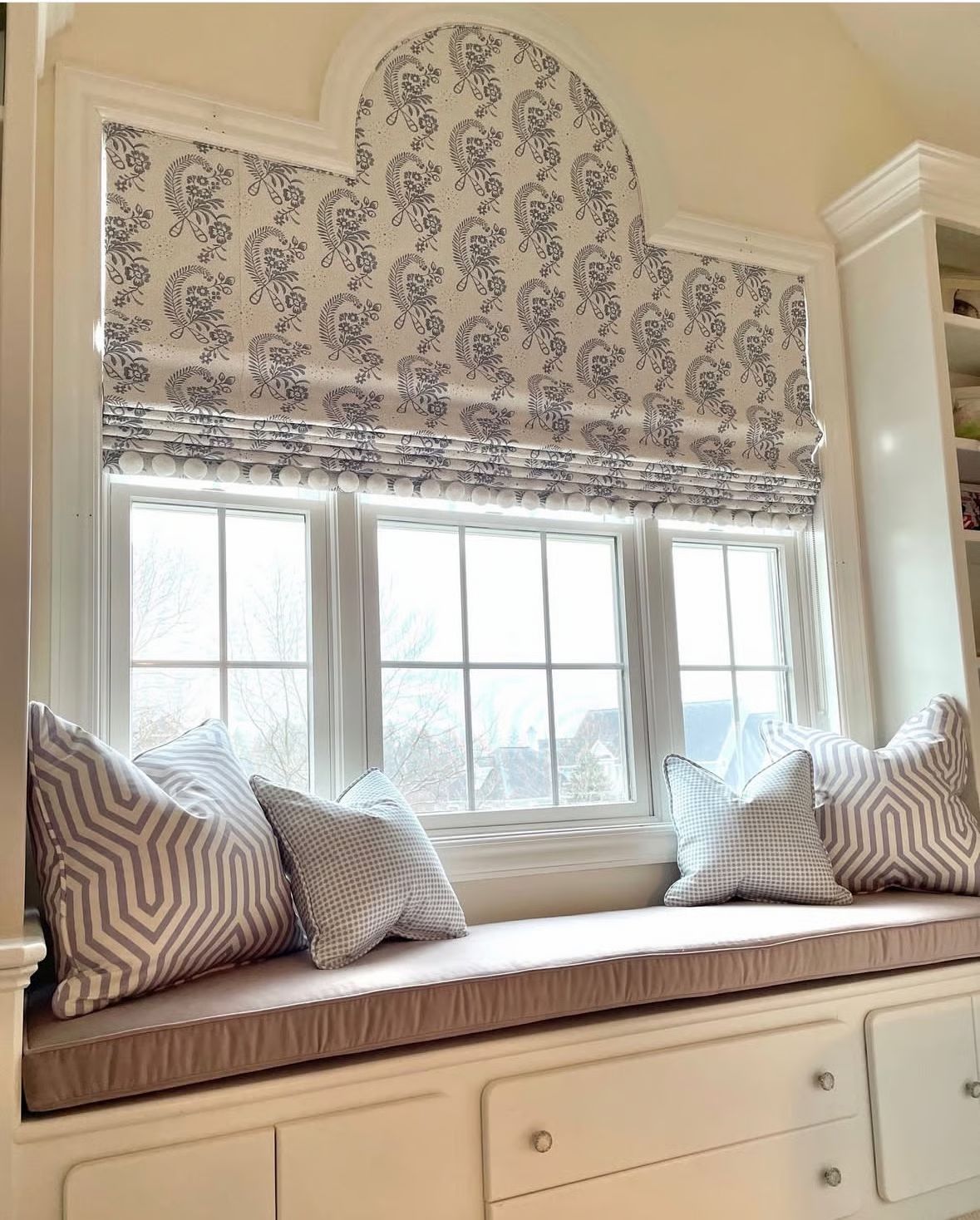 Arched roman shade with pom-pom trim